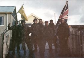 OS Members of 3 PARA hoisting flags at Stanley