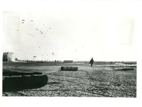 Last of first lift of 3 PARA dropping on El Gamil airfield. Men are making for their RVs. November 5, 1956.