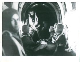 Waiting to drop. New Delhi, 1941. Men sit nervously inside a cramped aircraft.