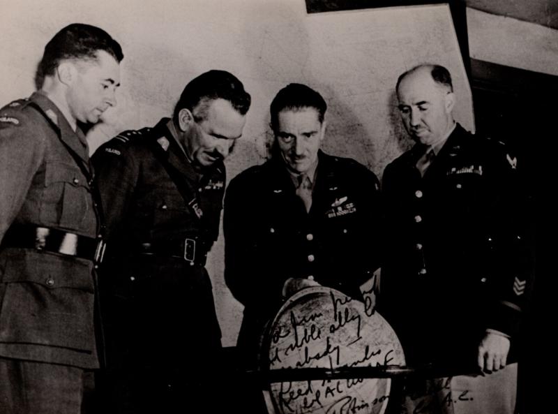 AA Sosabowski with officers looking at a globe