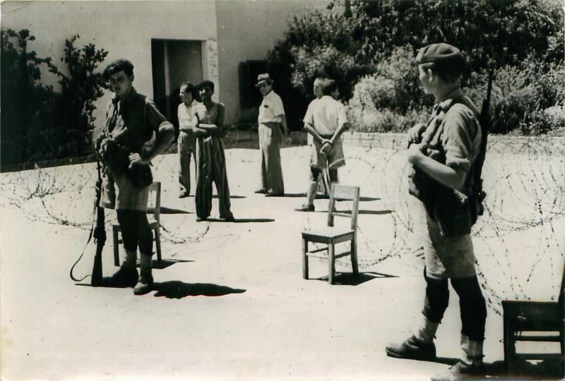 Paratroopers guard a huge arms cache found in a school basement in Tel Aviv.