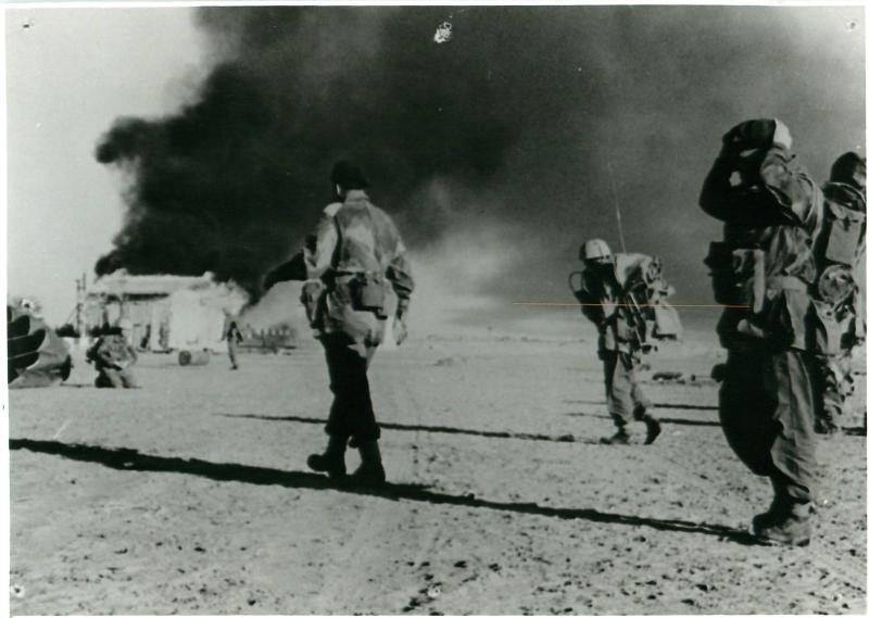 Colonel Paul Crook (left) and his tactical headquarters walk towards El Gamil airfield's control tower after dropping.