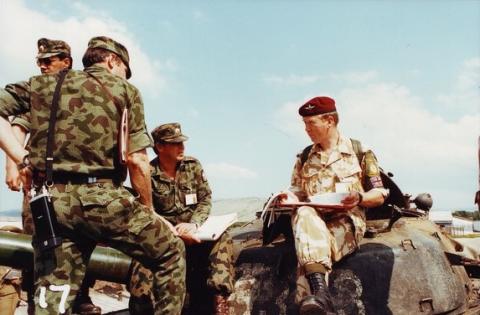 OS Donald  Robertson sitting on armoured vehicle with Russian soldiers.