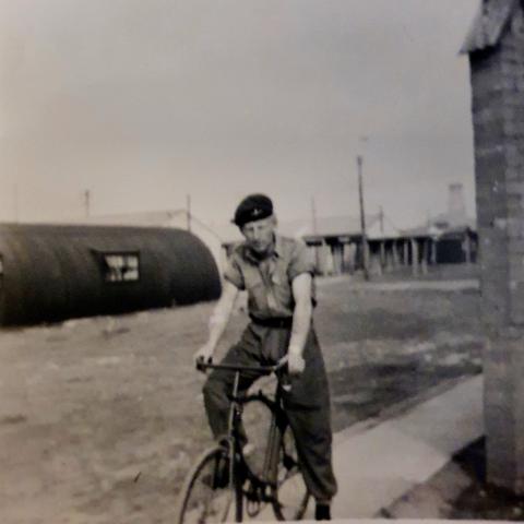 OS George Stainthorpe riding a bicycle