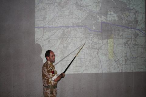 OS Iain Bayliss pointing at wall map