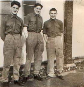 Three soldiers pose outside PCAU Living Quarters. 1955. 