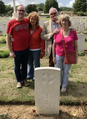 The family of R.G.Parsons around his grave at Ranville Cemetery, 2019