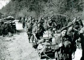 9th Parachute Battalion file past carrying equipment, Germany, March 1945