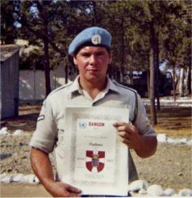 Charles M Preece with diploma certificate and UN beret