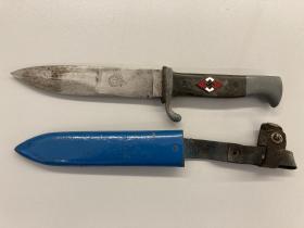 Colour photo of nazi dagger and scabbard.  Dagger has Nazi symbol and scabbard is painted blue.