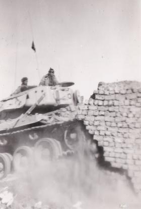A Centurion tank demolishing houses in Gaynaeim, following trouble from snipers. Canal Zone, Egypt. 8 Dec 1951