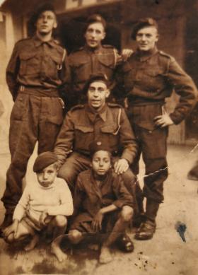 A group of four men from the 2nd Parachute Battalion, with two local boys in North Africa in November/December 1942.