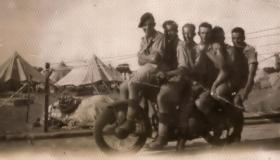OS Group on a motorcycle, possibly in Palestine