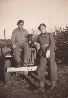 Pte Haysom with his friend, a dog and jeep 