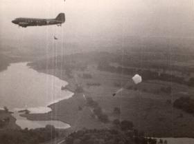 AA View of Dakota with paratroopers exiting