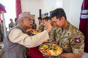 OS a Gurkha soldier receives a tika and blessings from Pandit Shiva Prasad Niraula