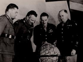 Sosabowski with officers looking at a globe