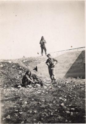 Leslie Jenner (crouching) by the roadside with men of 7th Bn.