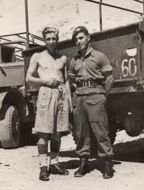 Private Leslie Jenner standing in front of a truck with a friend in Palestine