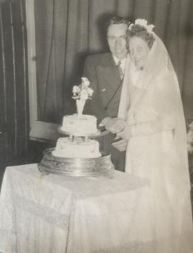 OS James Spencer on his wedding day, cutting the cake with his wife. 