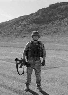 OS M Flynn carrying rifle wearing helmet and googles