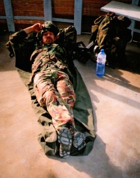 Cpl ‘Bob’ Morgan, 12 Platoon, D Coy, 2 PARA, resting in the hut next to Bridge Road vehicle check point, Sierra Leone, May 2000.