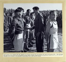 Major General AJH Cassels congratulates the Cross Country Running team of the 8th Parachute Battalion, 1946.