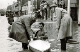 Capt McDonnell, REME, left, assisting during Taunton Flood, 1960.