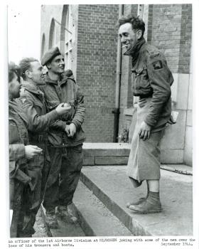 An officer of 1st Airborne Division jokes about his lack of trousers after crossing the river Rhine.
