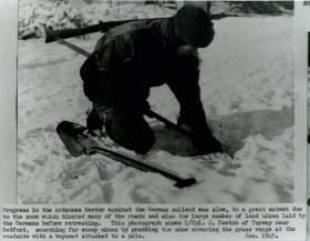 Lance Corporal Newton searching for enemy mines in the snow.