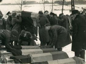 British Paras lift coffins of civilians executed in the Bande atrocity.