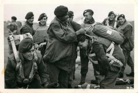 Paratroopers have their kit checked before emplaning.