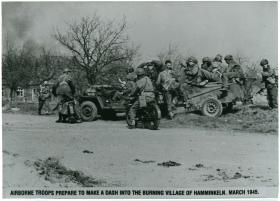 Airborne troops prepare to make a dash into the burning village of Hamminkeln. March 1945.