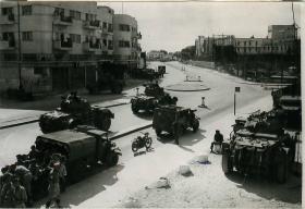 Armoured cars of 6th AB Div await orders to begin patrols in Tel Aviv.