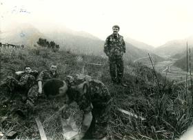 B Company 1 PARA pause on a grassy slope before patrolling, Hong Kong, 1980
