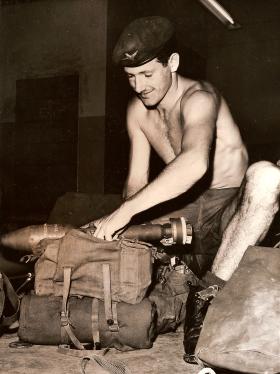 3 Para soldier preparing kit before a foot patrol, Aden, 1964