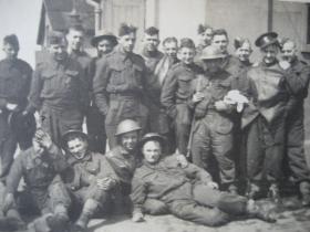 Group portrait of 70th Battalion, Royal East Kent Regiment 'The Buffs', relaxing at RAF Manston, 1941