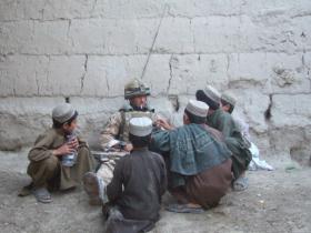 Member of 3 PARA spending time with local children in Afghanistan, 2008