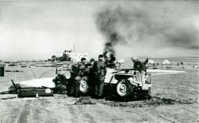Paratroopers surround a jeep on El Gamil airfield, November 1956