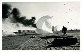 Paratroopers of A Company, 3 PARA move in to take the airport centre of El Gamil airfield while other men are still descending.