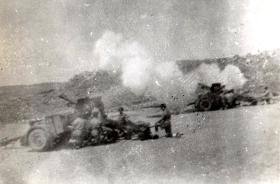Members of the 211 Airlanding Light Battery RA firing a 25 Pounder Artillery gun, Asluge, Palestine, 6 July 1946.