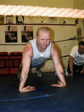 Paddy Doyle breaking record for most back of hands push ups in one hour