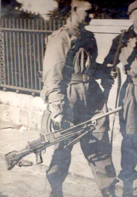 Pte 'Fred' Cutting carrying Bren light machine gun with rear handle visible, 1941.