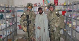 Doctors from 16 Medical Regiment, RAMC, with a local pharmacist, Afghanistan, 2011