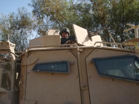 Pte Dan Prior Providing Top Cover from a Husky Vehicle, Afghanistan, 2010