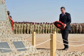 The Minister of Defence, Dr Liam Fox, lays a wreath, with 16 Air Assault soldiers in the background, Afghanistan, 2010