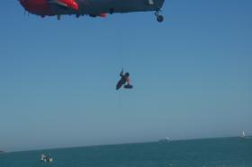 A winchman from an RNAS Culdrose helicopter lays a wreath at the Trebah Military Day 2009