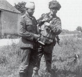 Pte Durston with a German Prisoner at the Escarde Crossroads, June 1944.