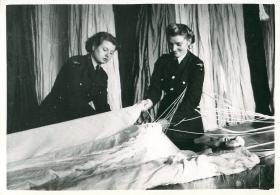 Two female parachute packers at work.