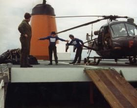The RN Deck Crew celebrate the successful landing of the helicopter, MV Norland, 1982